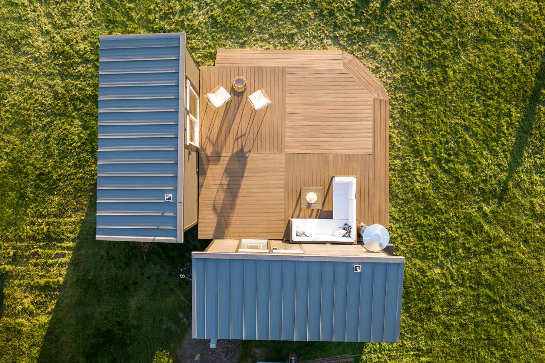 Aerial view: Kingdom L-Combo tiny home layout. See the two-section design with outdoor deck for additional living area.