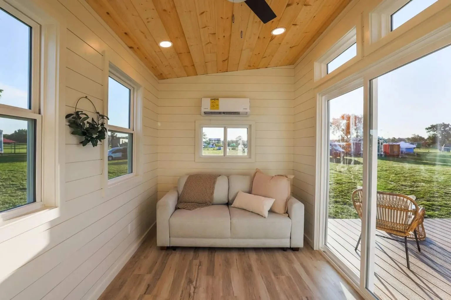 Modern, light-filled Kingdom 150 tiny home interior with cozy furnishings and ample storage space