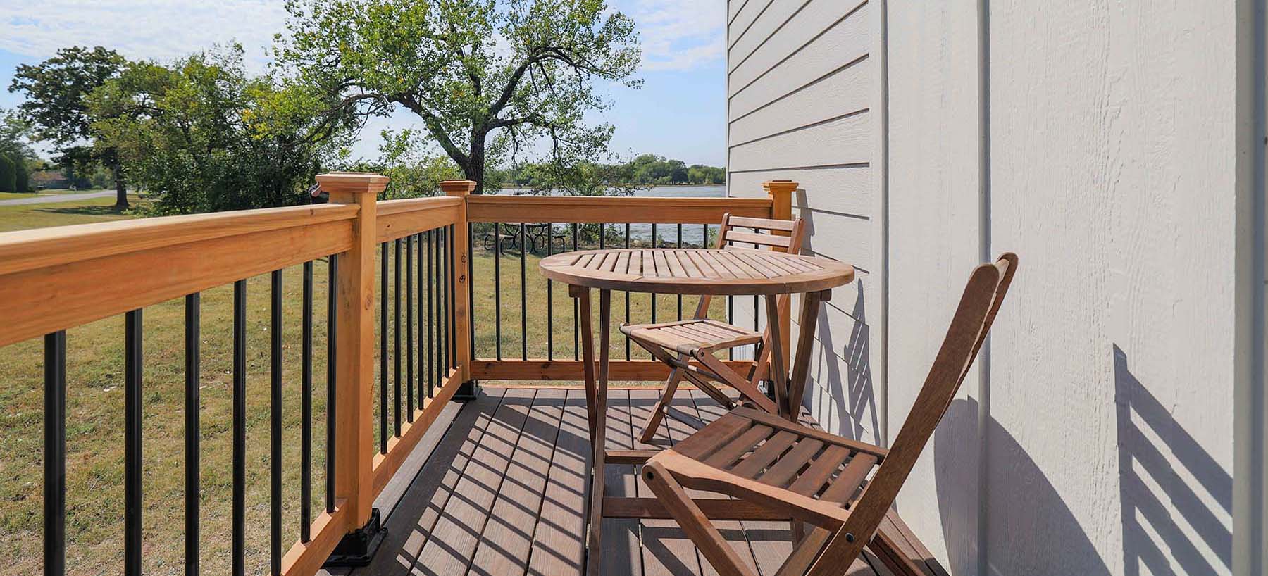 Spacious outdoor deck on Kingdom L Combo tiny home. Relax & entertain with ample seating for 150+. 