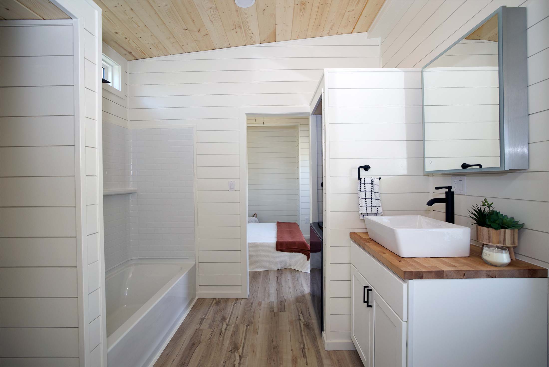 Kingdom L Combo bathroom view. Modern, open concept with shower and vanity. Ideal for tiny home living. 