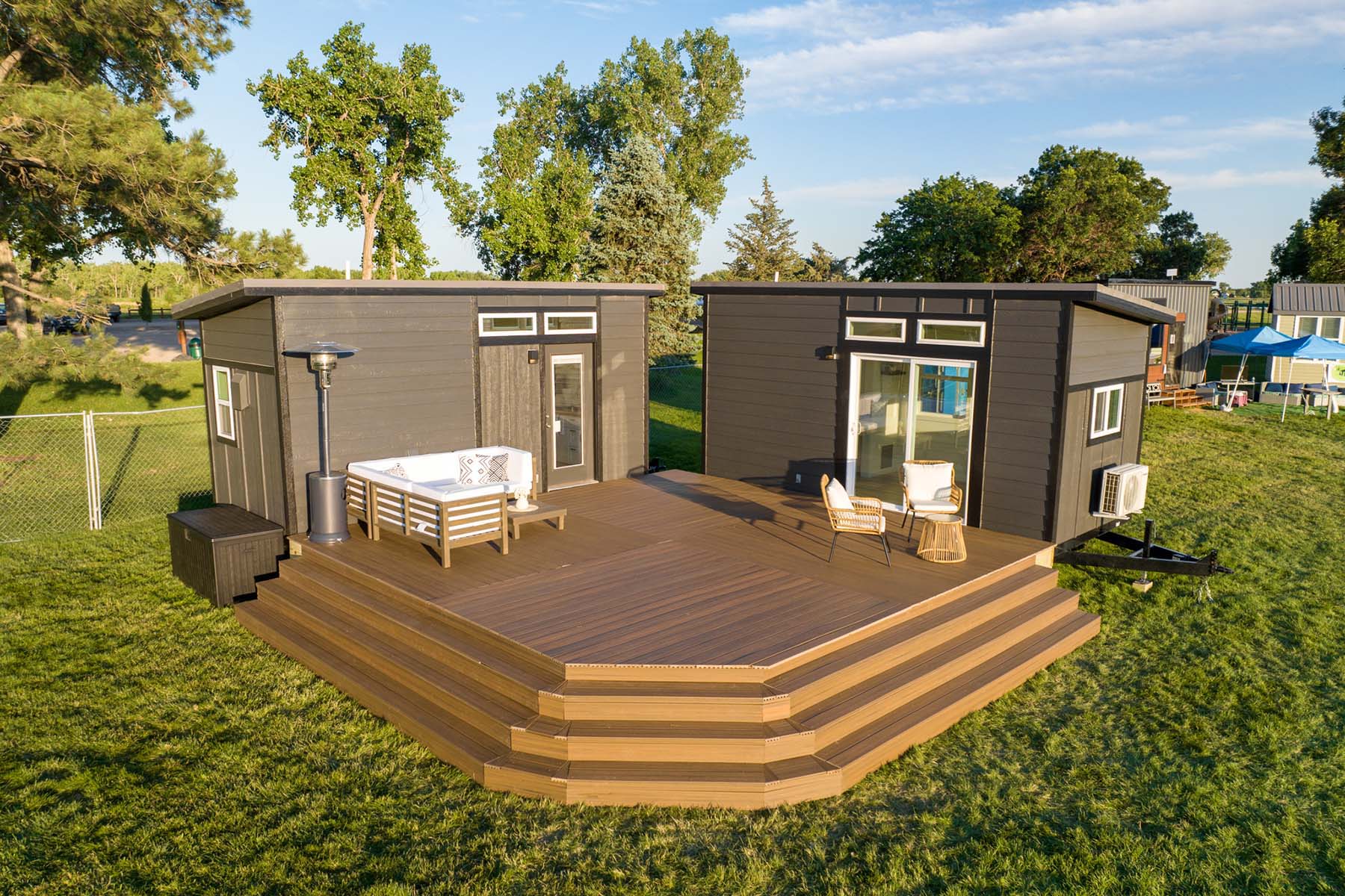 Dreamy Exterior View: L-Shaped Tiny Home with Deck 